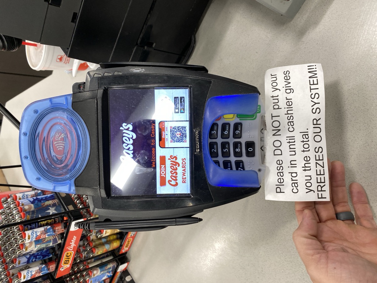 Casey's payment terminal with warning sign