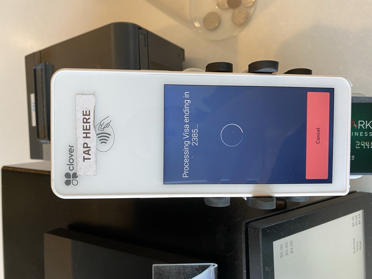 Clover payment terminal with tap here sign